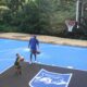 One of FlexCourt's backyard courts with a child throwing a basketball