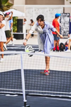 woman returning a serve in a pickleball game