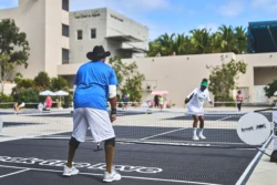 man and woman playing pickleball against each other