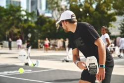 man returning a serve while playing pickleball