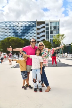 Family posing in front of the pickleball courts at Jungle Plaza